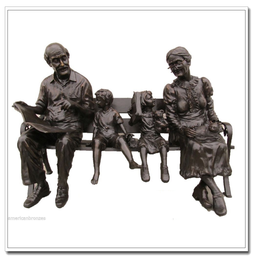 Old couple with grandchildren sitting on bench bronze statues